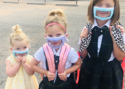 Anna and her sisters with clear masks