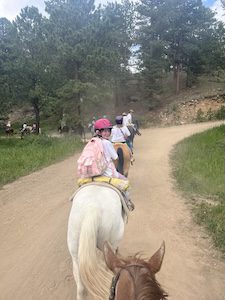 Lily with cochlear implant on horseback